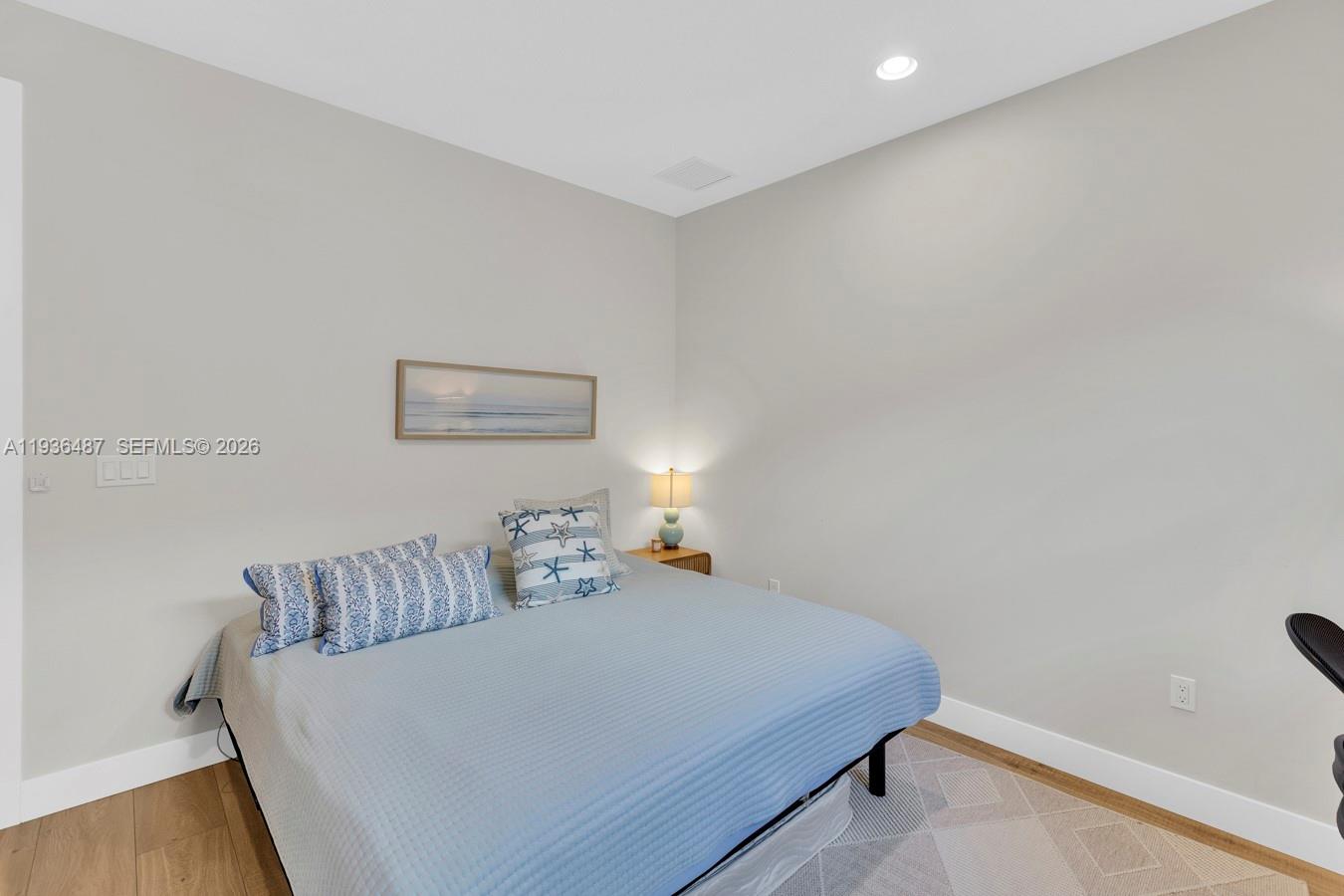 20310 Whistling Straits Way Boca Raton, FL 33434 - Photo 51 of 73 a bedroom with a bed and a lamp with wooden floor