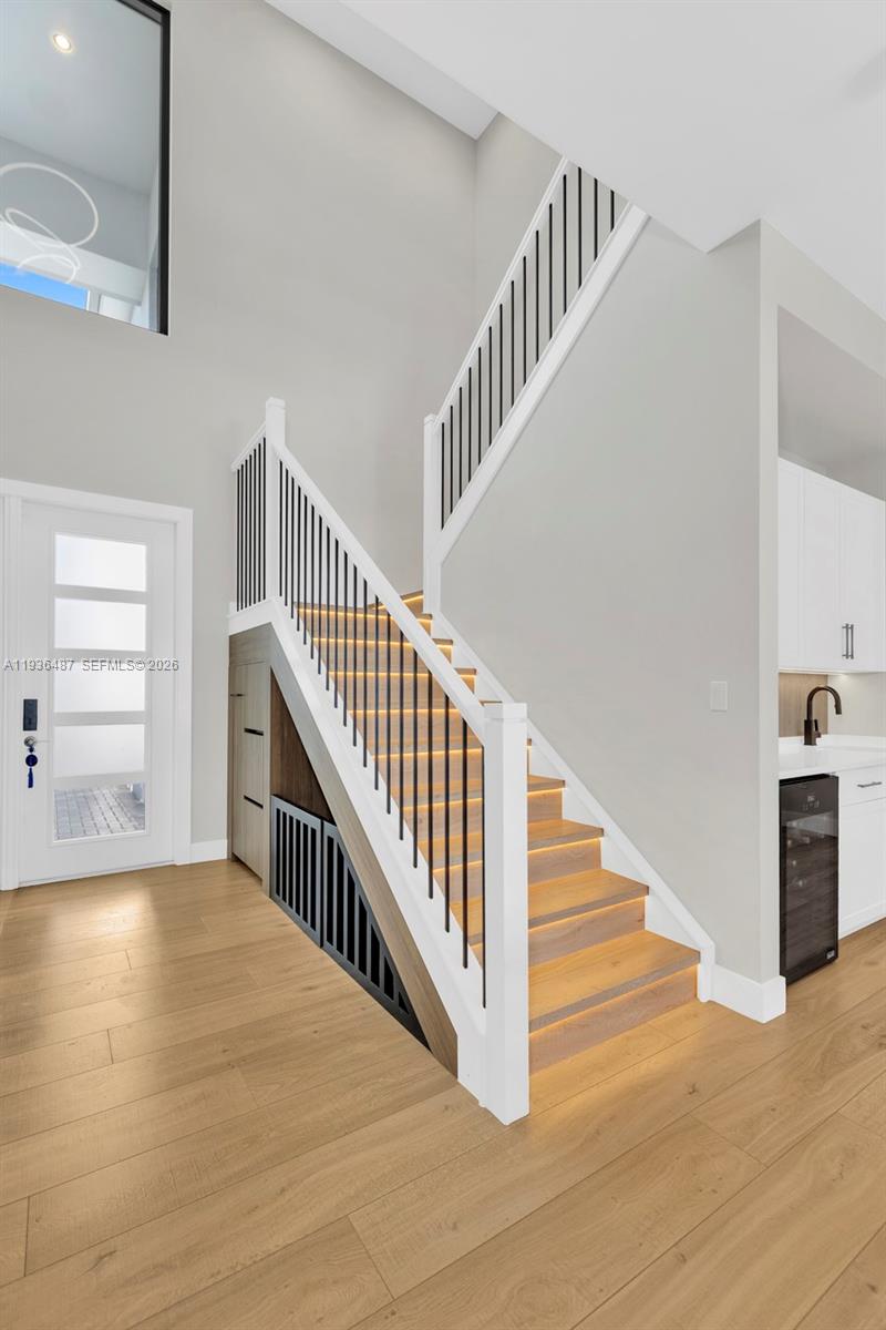 20310 Whistling Straits Way Boca Raton, FL 33434 - Photo 6 of 73 a view of staircase with lots of frames and a wooden floor