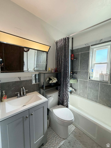 156 D Street Helper, UT 84526 - Photo 17 of 24 Bathroom featuring vanity, shower / bath combo, and light tile patterned floors