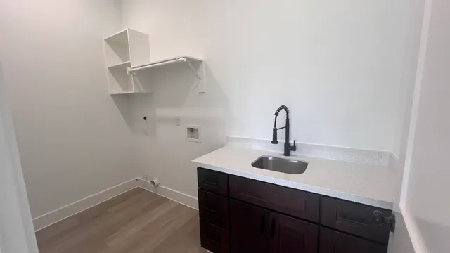 a close view of a sink and cabinets in the room