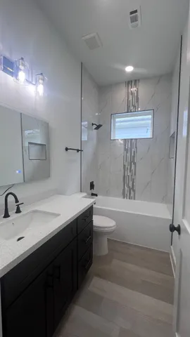 a bathroom with a sink a toilet and a bathtub
