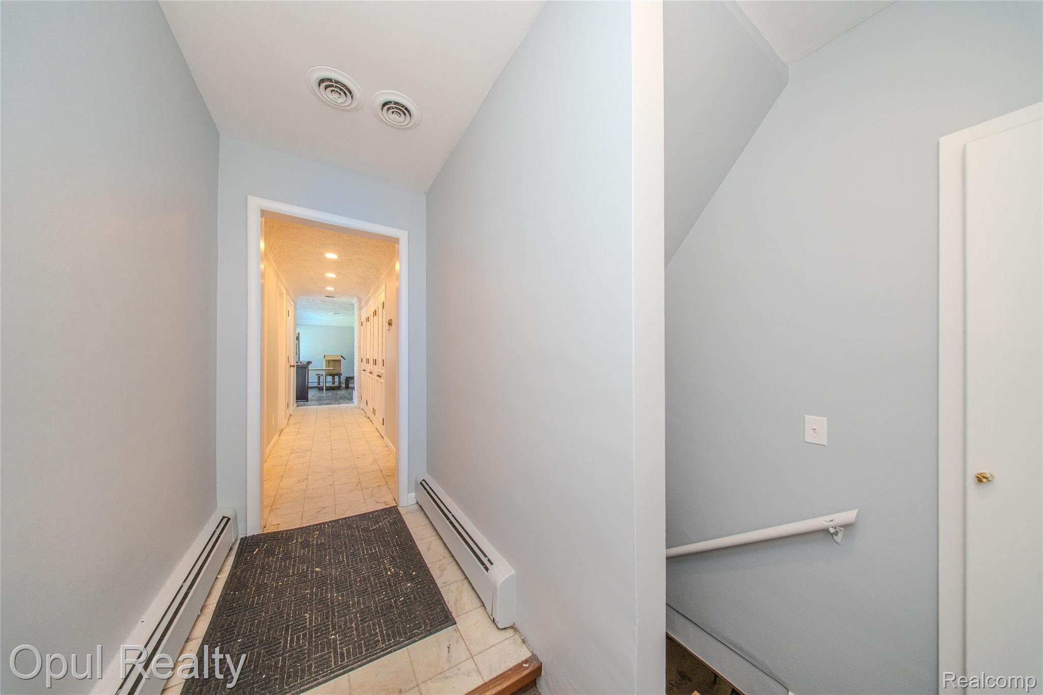 6455 Norham Road Bloomfield Hills, MI 48301 - Photo 31 of 93 Hallway featuring tile flooring, ceiling-mounted lighting, and baseboard heating