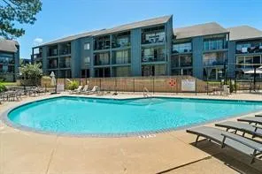 a view of house with a backyard space and balcony