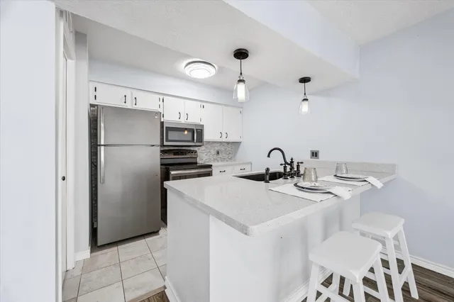a kitchen with stainless steel appliances a refrigerator and a stove