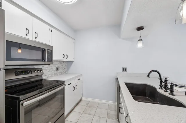 a kitchen with a sink stove and microwave
