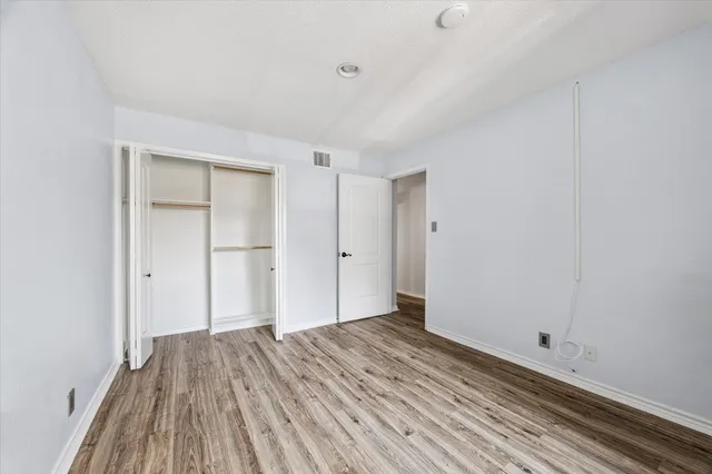 a view of a room with wooden floor