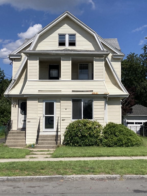 425 Springfield Street Chicopee, MA 01013 - Photo 1 of 1 a front view of a house with a yard