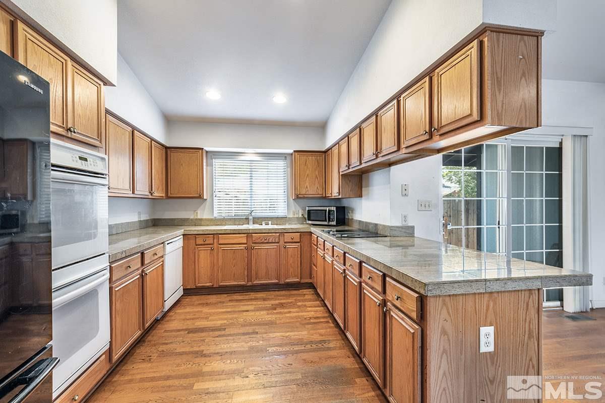1390 Washington Street Reno, NV 89503 - Photo 2 of 16 a kitchen with stainless steel appliances granite countertop a stove and cabinets