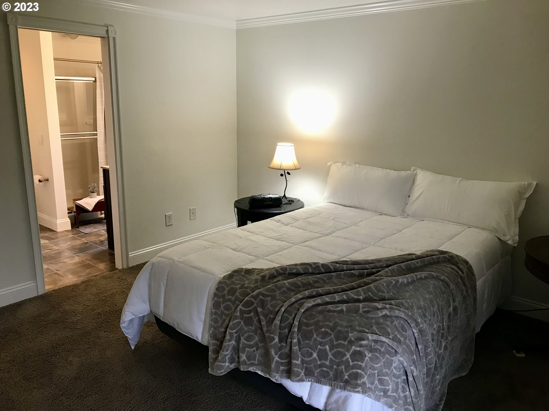 7175 Southwest 173rd Avenue Beaverton, OR 97007 - Photo 14 of 20 a bedroom with a bed and a lamp