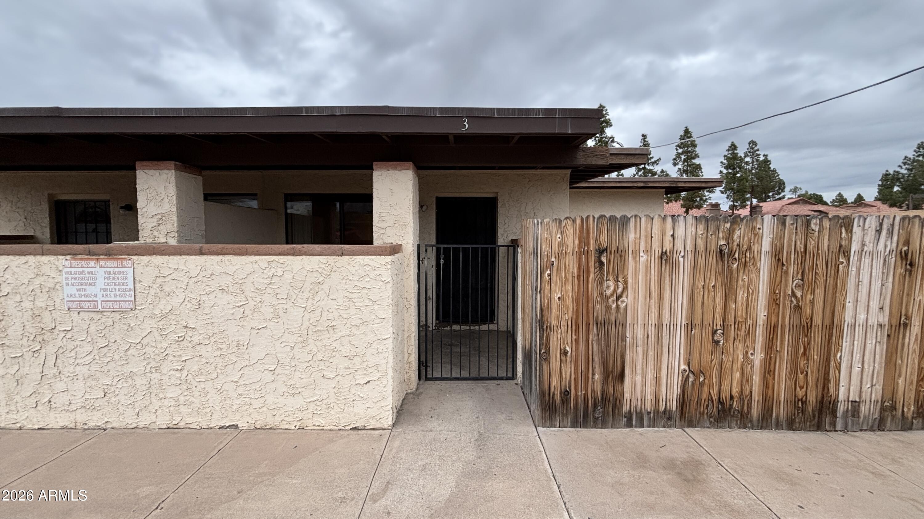 a view of a house with a wooden fence