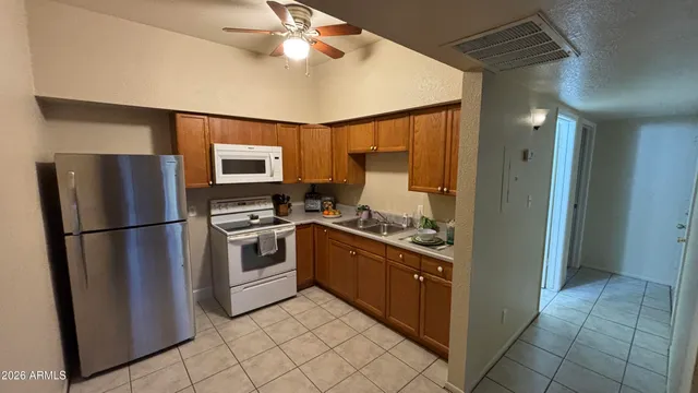 a kitchen with stainless steel appliances a refrigerator sink and cabinets