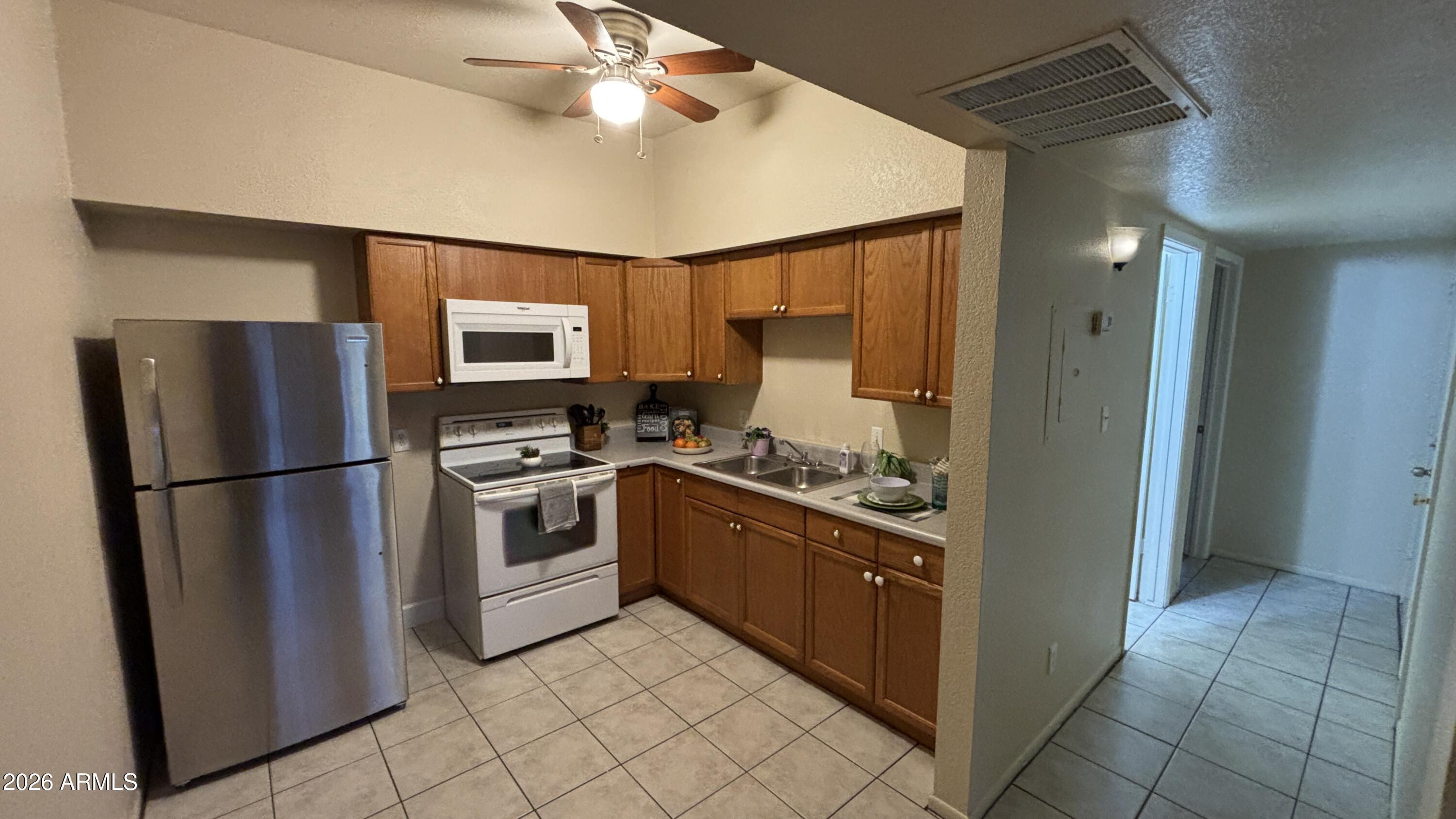 1301 West 3rd Street, Unit 3 Tempe, AZ 85281 - Photo 5 of 16 a kitchen with stainless steel appliances granite countertop a refrigerator a stove and a sink
