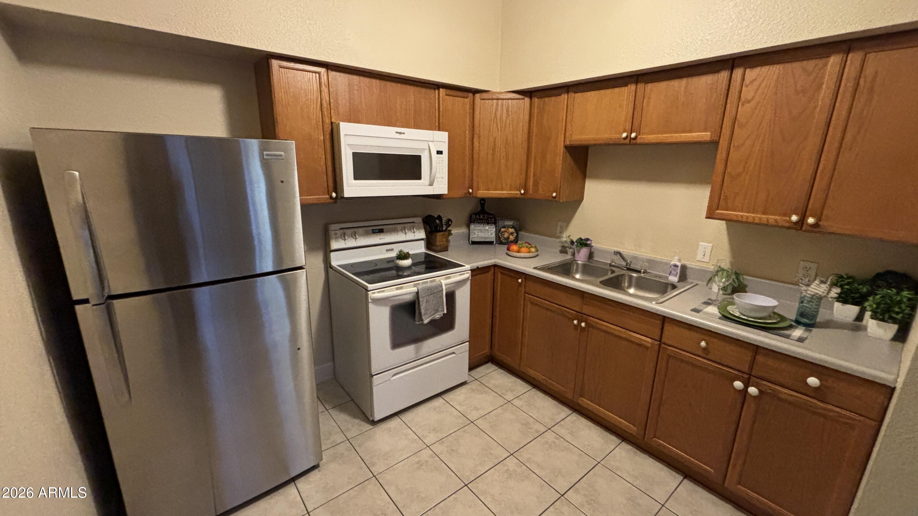 1301 West 3rd Street, Unit 3 Tempe, AZ 85281 - Photo 6 of 16 a kitchen with stainless steel appliances a refrigerator sink and cabinets