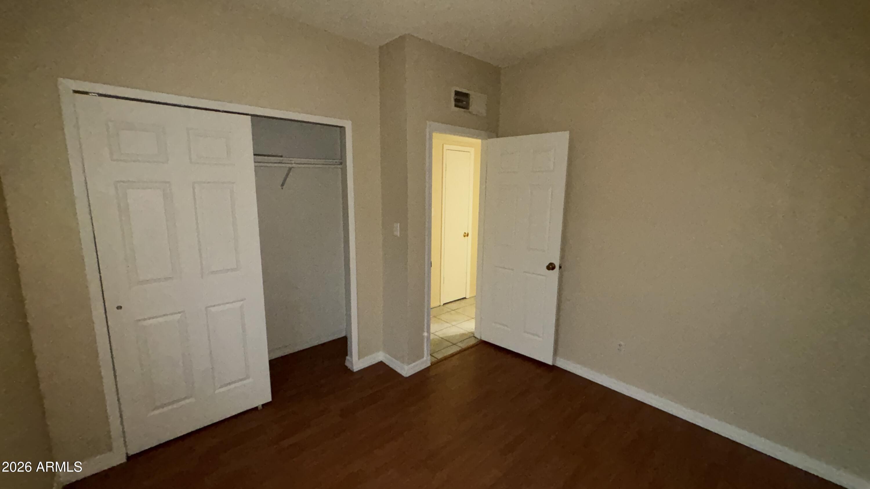 1301 West 3rd Street, Unit 3 Tempe, AZ 85281 - Photo 10 of 16 an empty room with wooden floor and closet