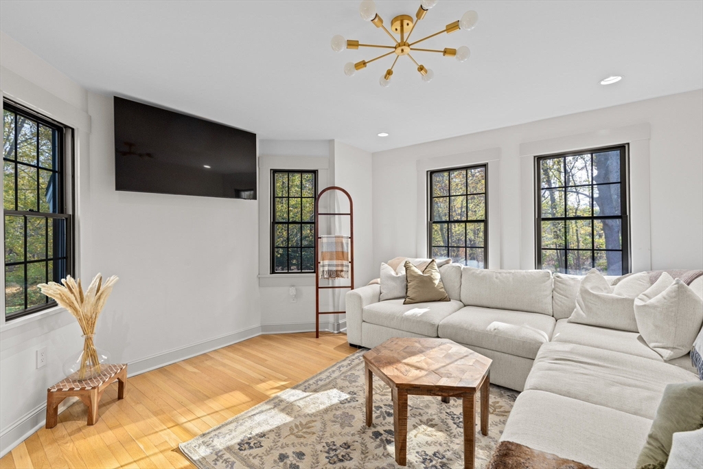 348 Main Street Norwell, MA 02061 - Photo 15 of 42 a living room with furniture a flat screen tv and a large window