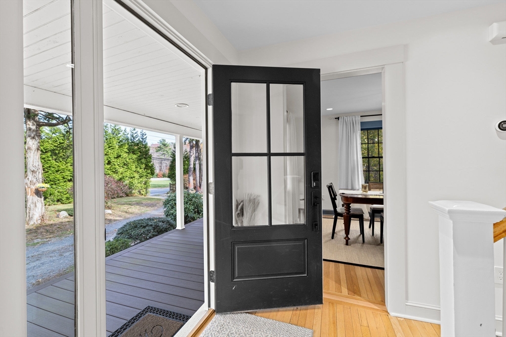 348 Main Street Norwell, MA 02061 - Photo 17 of 42 a view of a hallway with wooden floor and dining room view