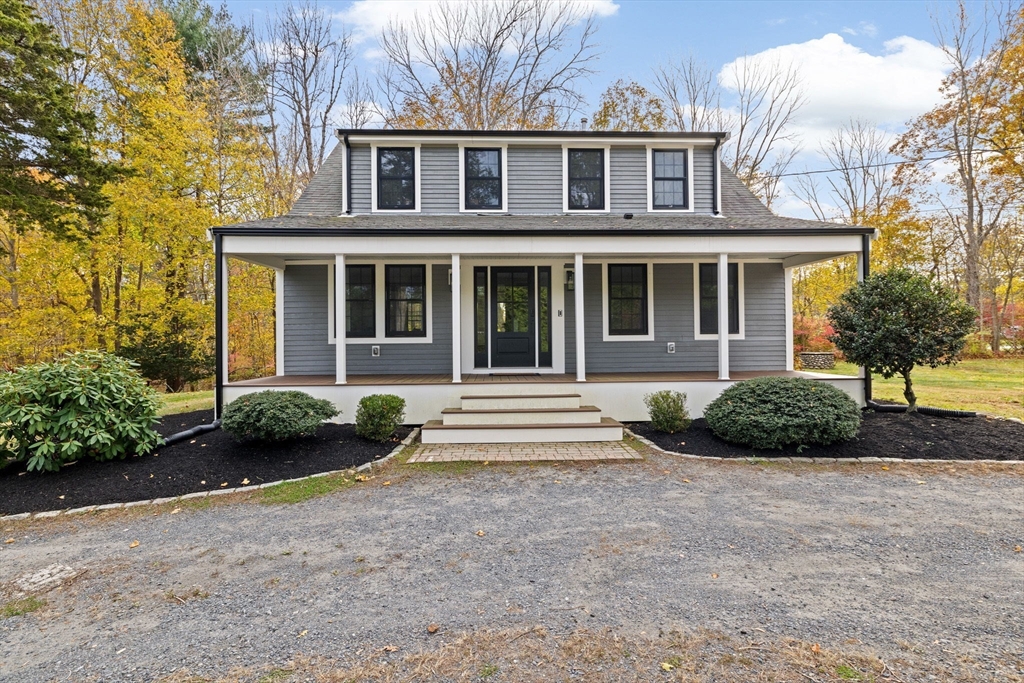 348 Main Street Norwell, MA 02061 - Photo 32 of 42 a front view of a house with a garden and plants