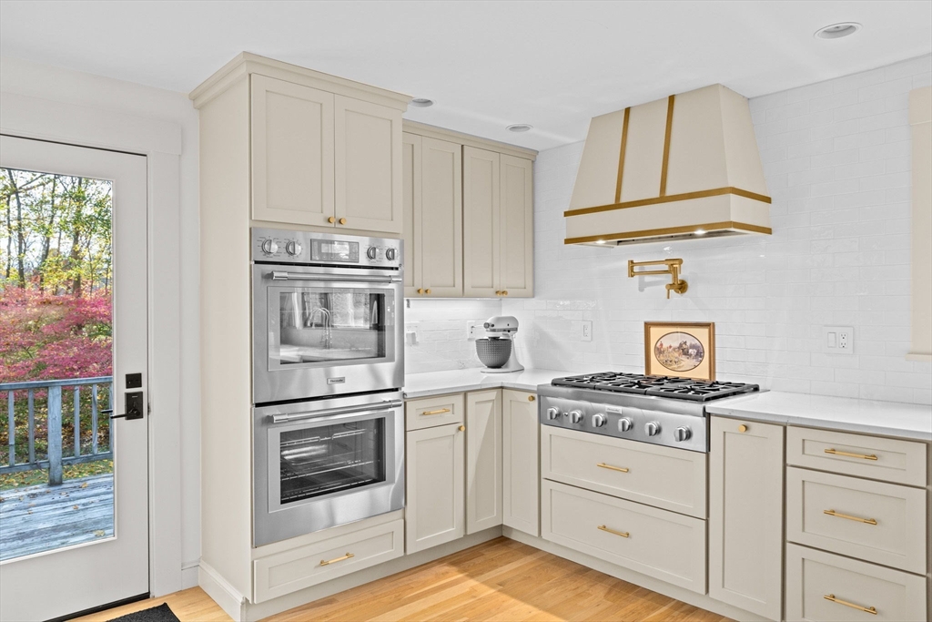 348 Main Street Norwell, MA 02061 - Photo 4 of 42 a kitchen with granite countertop white cabinets and stainless steel appliances