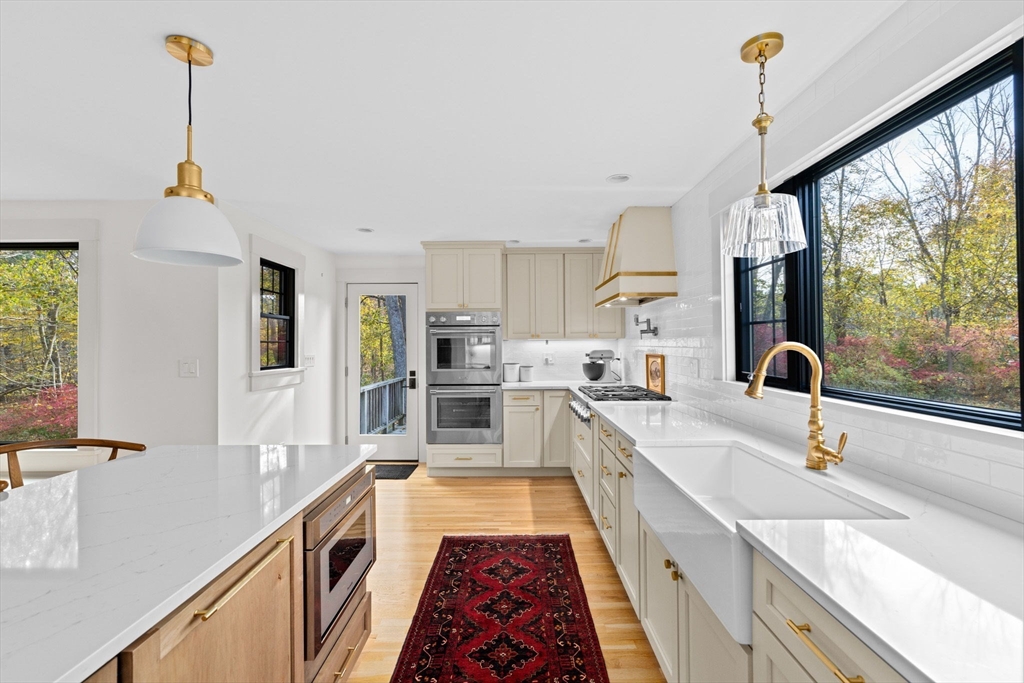 348 Main Street Norwell, MA 02061 - Photo 6 of 42 a large kitchen with granite countertop a sink and a wooden floor