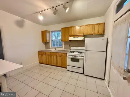 a kitchen with stainless steel appliances a stove a sink and a refrigerator