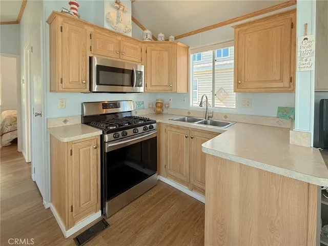 a kitchen with a sink stove top oven and cabinets