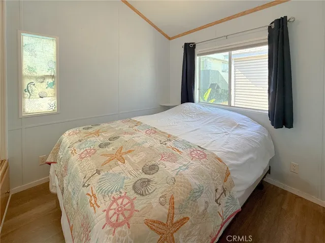 a large bed sitting in a bedroom next to a window