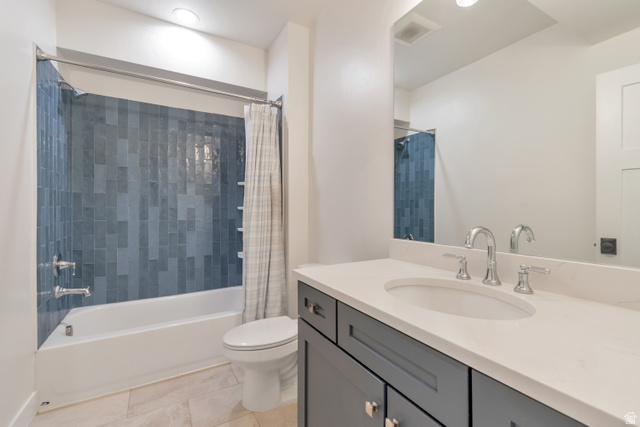 1820 West Farmhouse Flats Road Peoa, UT 84061 - Photo 43 of 79 Bathroom featuring a tub/shower combination with blue vertical-set tile surround, a white vanity with an undermount sink, chrome fixtures, and a large mirror