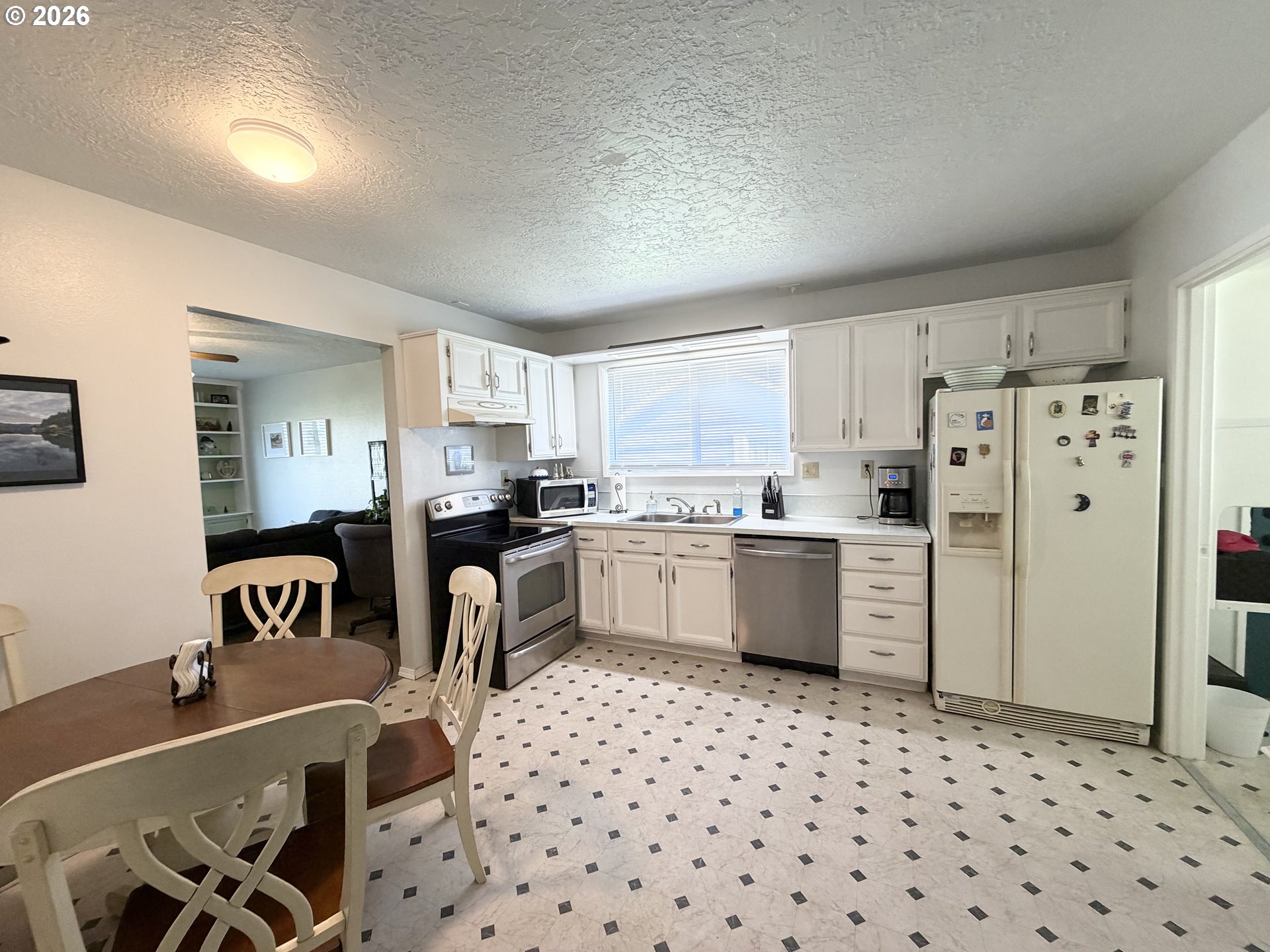 420 24th Avenue Longview, WA 98632 - Photo 11 of 21 a kitchen with granite countertop a refrigerator stove top oven and sink