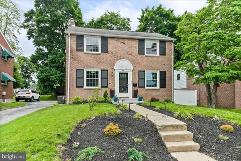 a front view of a house with a yard and porch