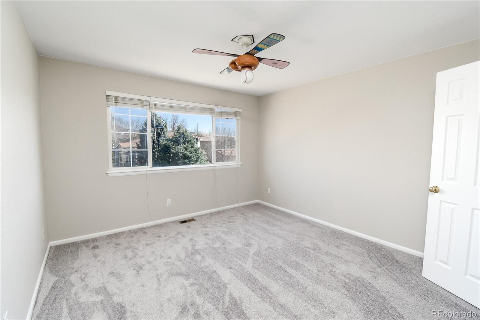 9265 Roadrunner Street Highlands Ranch, CO 80129 - Photo 17 of 28 an empty room with window and ceiling fan