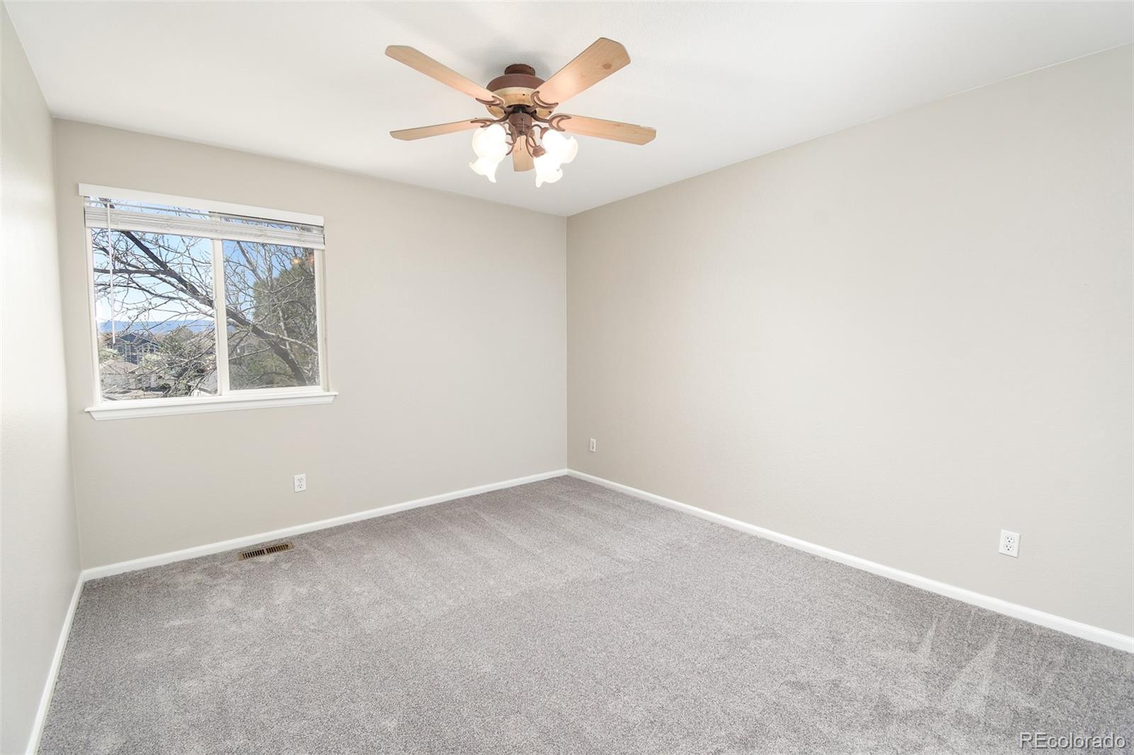 9265 Roadrunner Street Highlands Ranch, CO 80129 - Photo 23 of 28 an empty room with windows and fan