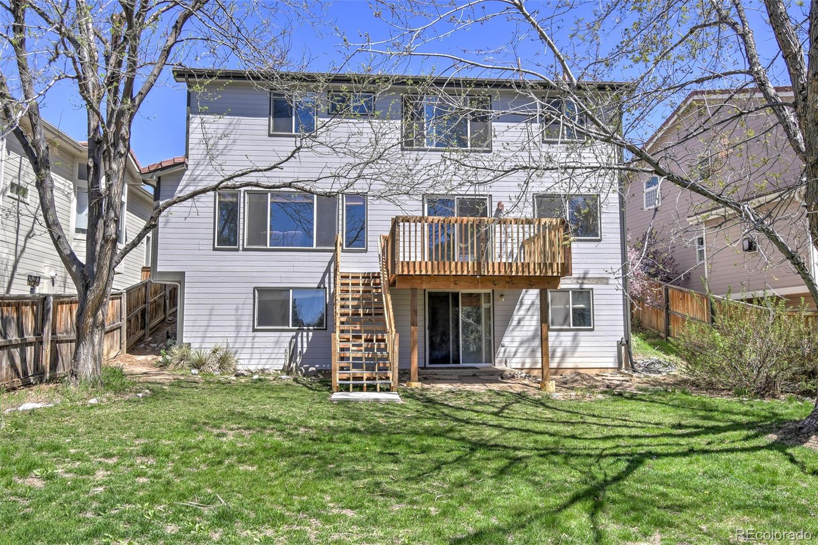 9265 Roadrunner Street Highlands Ranch, CO 80129 - Photo 26 of 28 a front view of a house with a garden