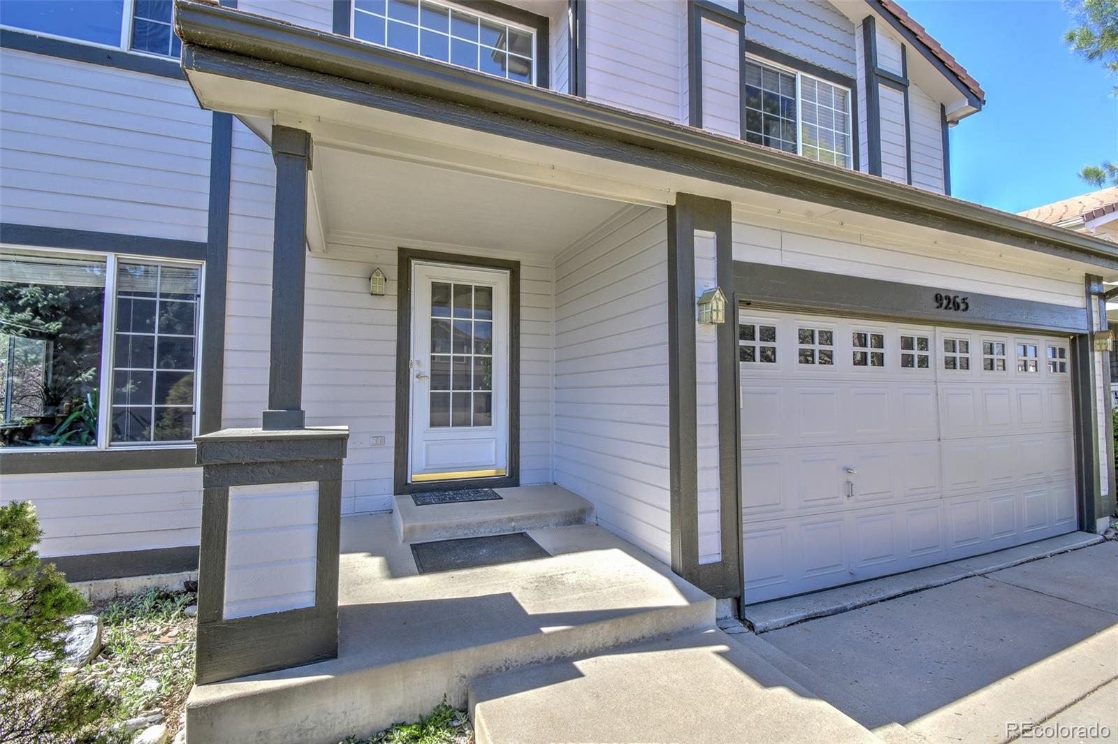 9265 Roadrunner Street Highlands Ranch, CO 80129 - Photo 3 of 28 a front view of a building with a porch