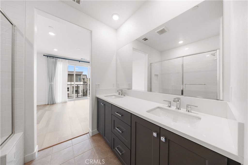 312 Tank Irvine, CA 92618 - Photo 40 of 75 a spacious bathroom with a double vanity sink and mirror