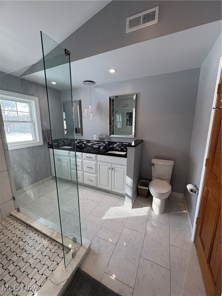 2504 Meloy Road Kent, OH 44240 - Photo 27 of 50 Bathroom featuring vanity, toilet, tiled shower, and vaulted ceiling