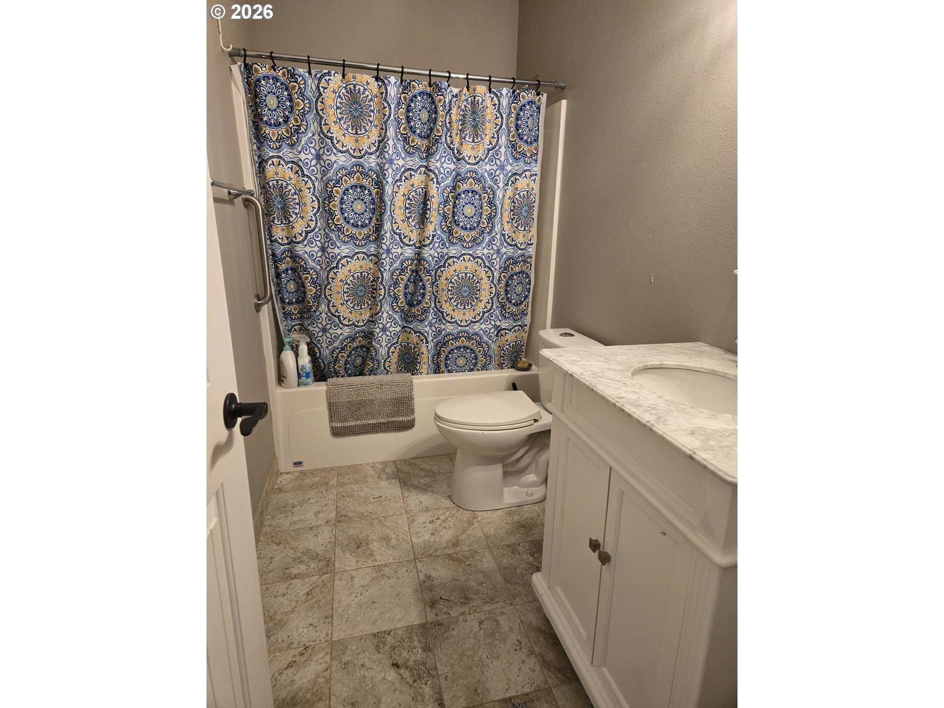 16817 Nonpareil Road Sutherlin, OR 97479 - Photo 16 of 39 a bathroom with a granite countertop toilet and a shower curtain