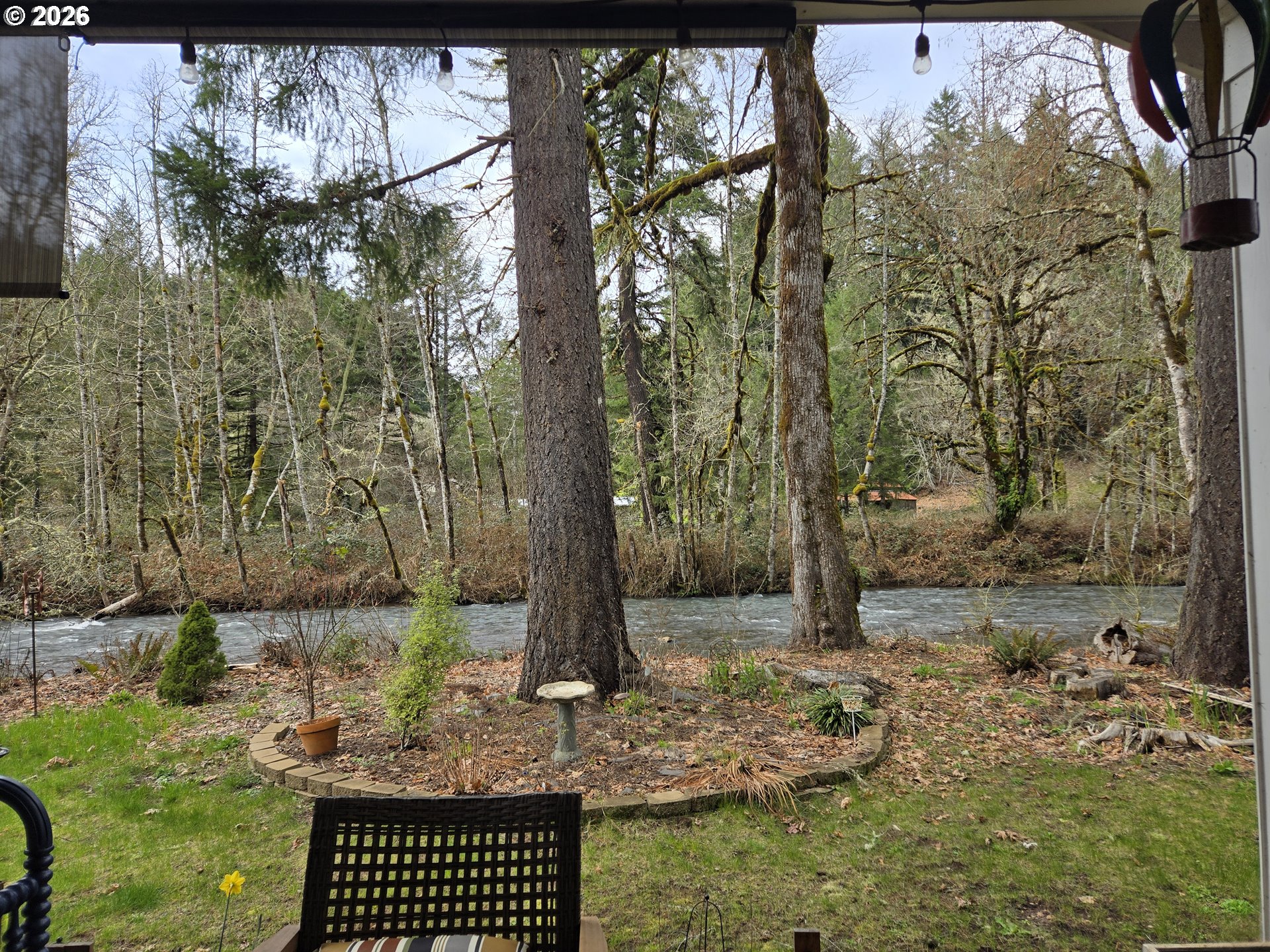 16817 Nonpareil Road Sutherlin, OR 97479 - Photo 23 of 39 a backyard of a house with large trees and wooden fence