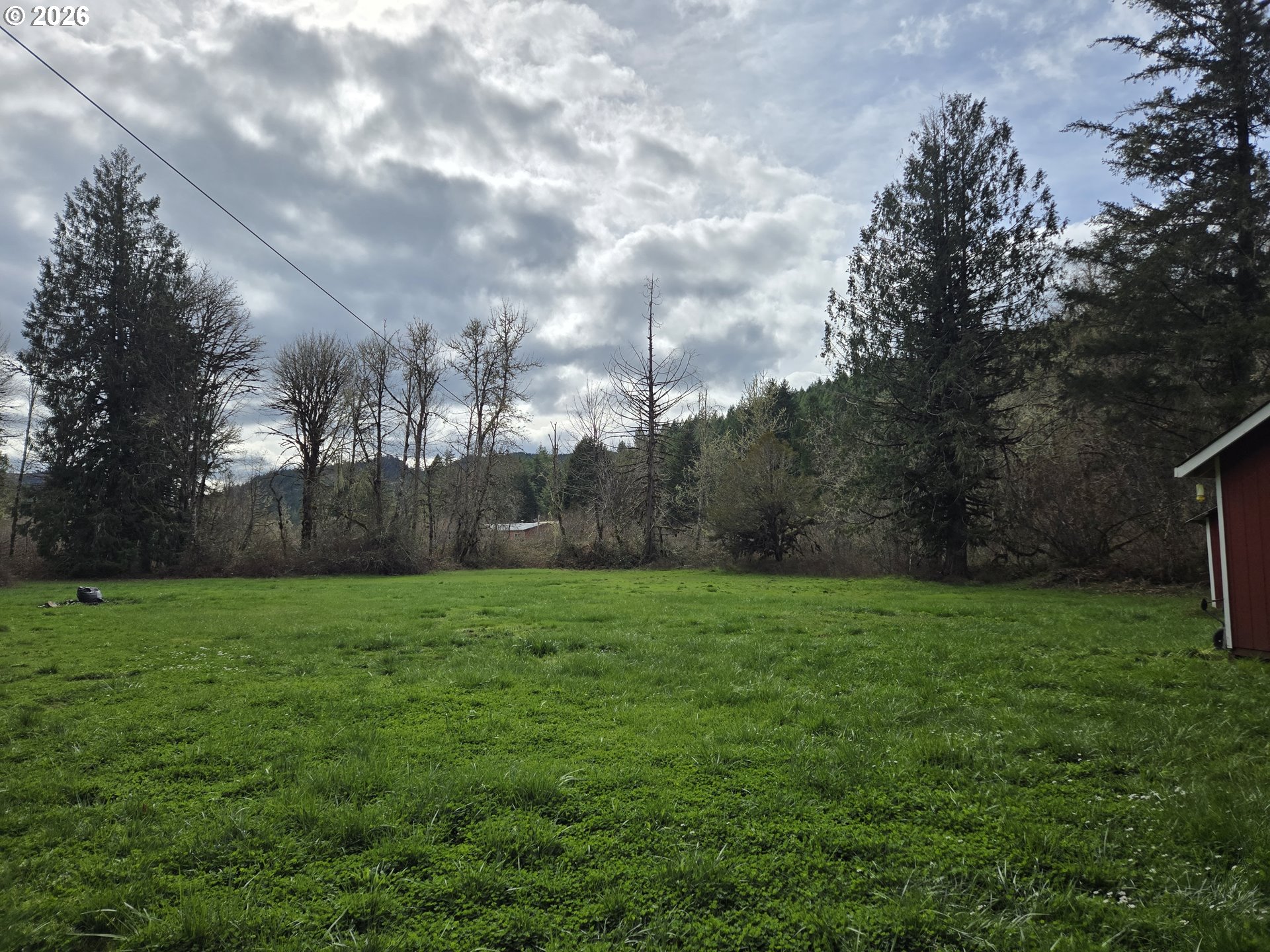 16817 Nonpareil Road Sutherlin, OR 97479 - Photo 27 of 39 a view of a grassy field with trees