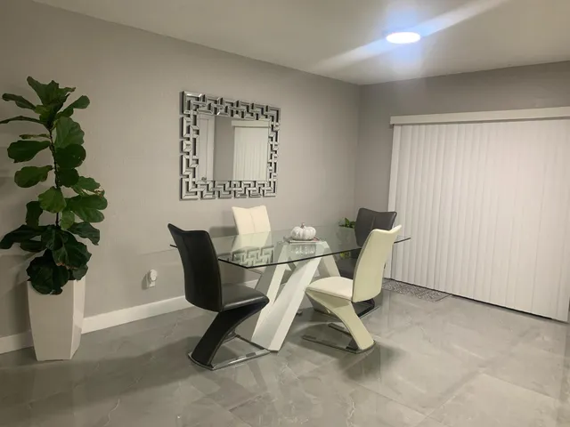 a view of a livingroom with furniture and a potted plant