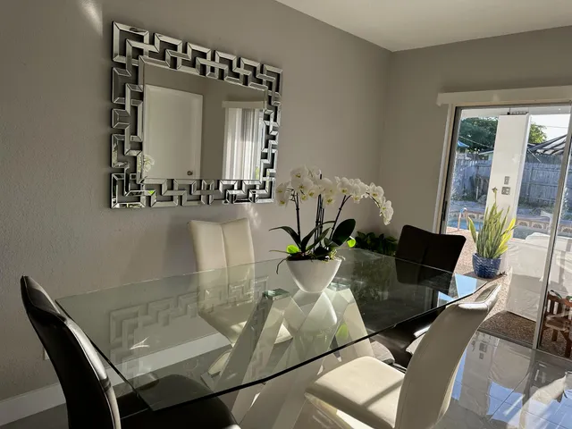 a view of a dining room with furniture and wooden floor
