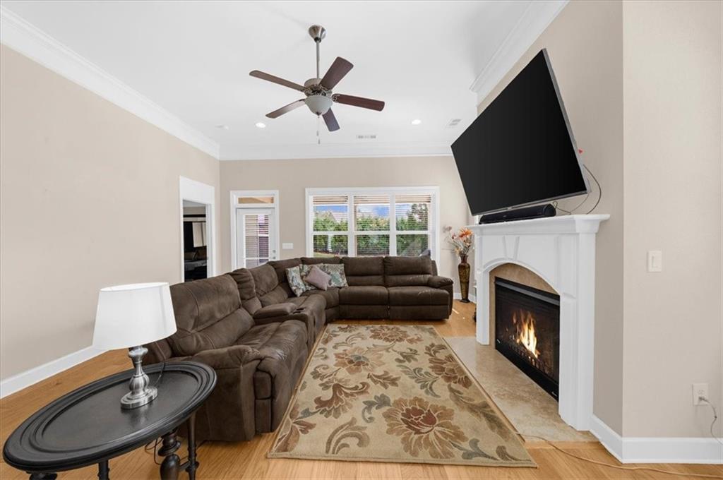 3739 Golden Leaf Point Southwest Gainesville, GA 30504 - Photo 11 of 60 a living room with furniture a fireplace and a flat screen tv