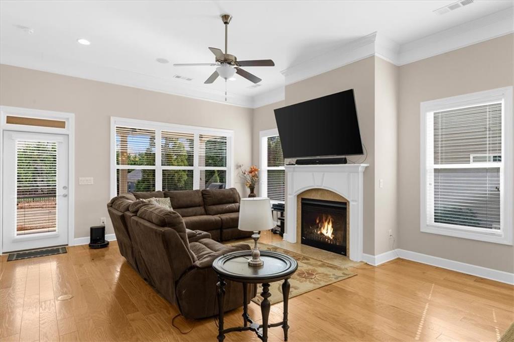 3739 Golden Leaf Point Southwest Gainesville, GA 30504 - Photo 12 of 60 a living room with furniture a flat screen tv and a fireplace