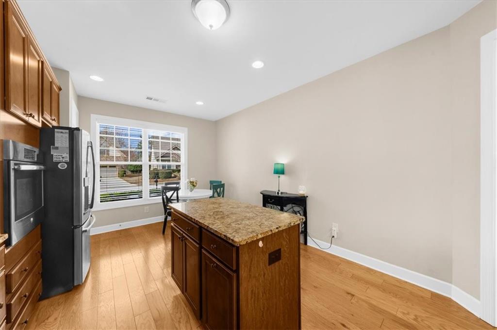 3739 Golden Leaf Point Southwest Gainesville, GA 30504 - Photo 17 of 60 a kitchen with a stove and refrigerator