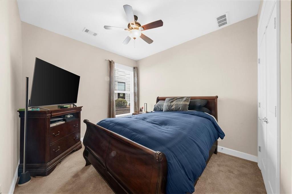 3739 Golden Leaf Point Southwest Gainesville, GA 30504 - Photo 25 of 60 a bedroom with a bed and a flat screen tv