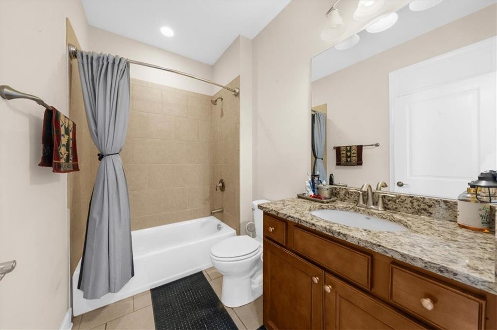 3739 Golden Leaf Point Southwest Gainesville, GA 30504 - Photo 26 of 60 a bathroom with a granite countertop sink toilet and shower