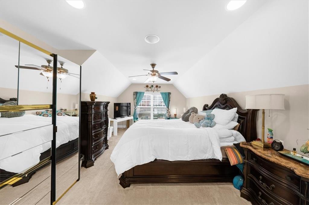 3739 Golden Leaf Point Southwest Gainesville, GA 30504 - Photo 29 of 60 a bed room with a bed and a chandelier