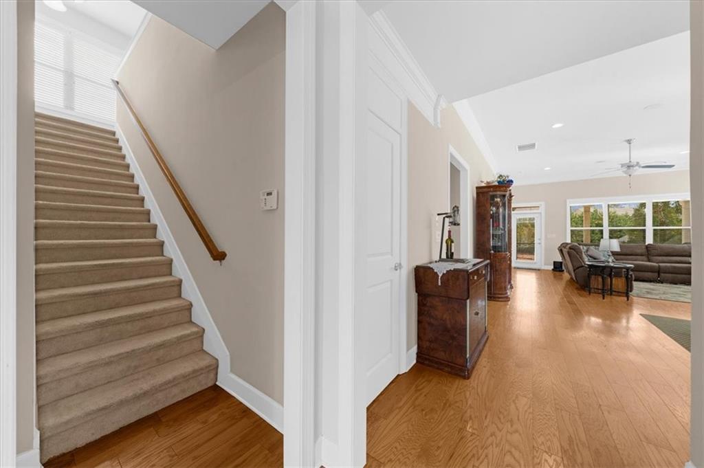 3739 Golden Leaf Point Southwest Gainesville, GA 30504 - Photo 6 of 60 a view of a living room and workspace with wooden floor and windows