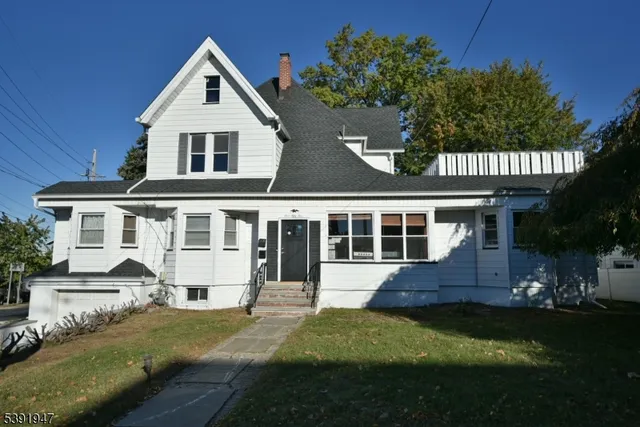 a front view of a house with a yard and porch