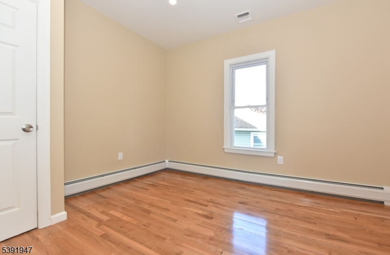 454 Park Avenue Rutherford, NJ 07070 - Photo 13 of 27 a view of an empty room with wooden floor and a window
