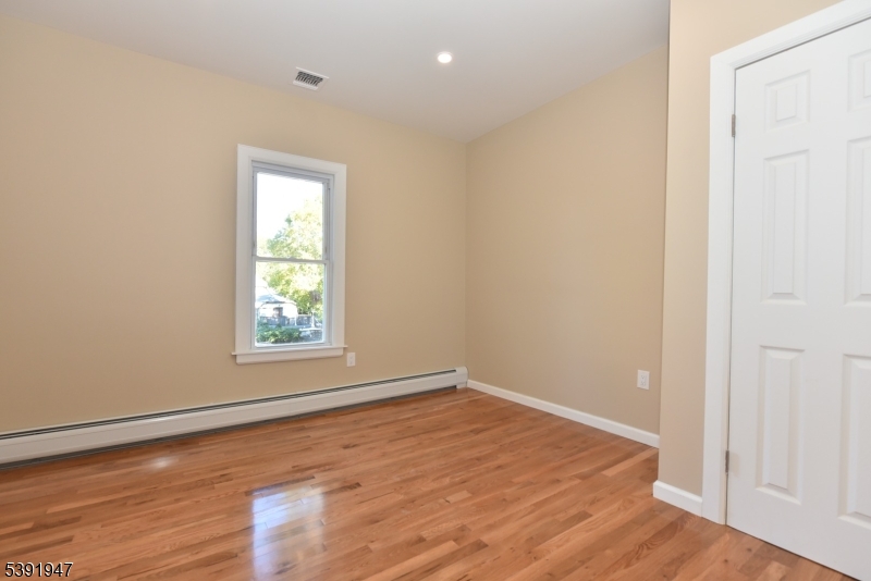 454 Park Avenue Rutherford, NJ 07070 - Photo 14 of 27 an empty room with wooden floor and windows